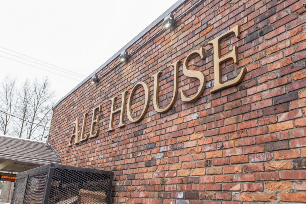 Ale House sign on brick wall