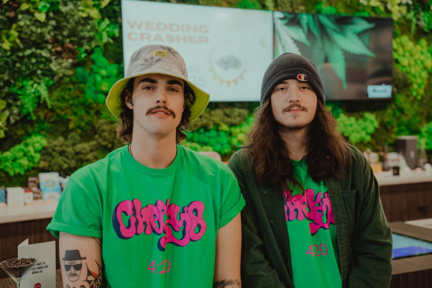 two staff in Cheeky's merch