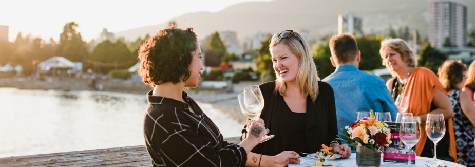 two women enjoying wine