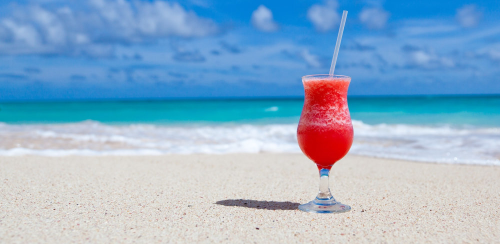 red fruity drink on the beach
