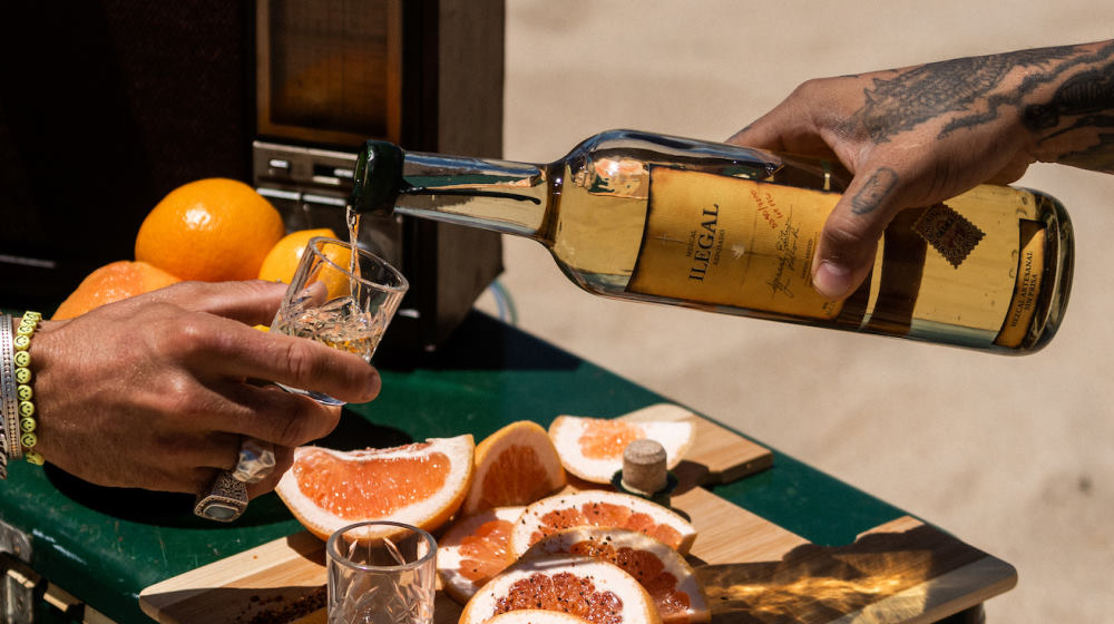 pouring Mezcal with citrus 