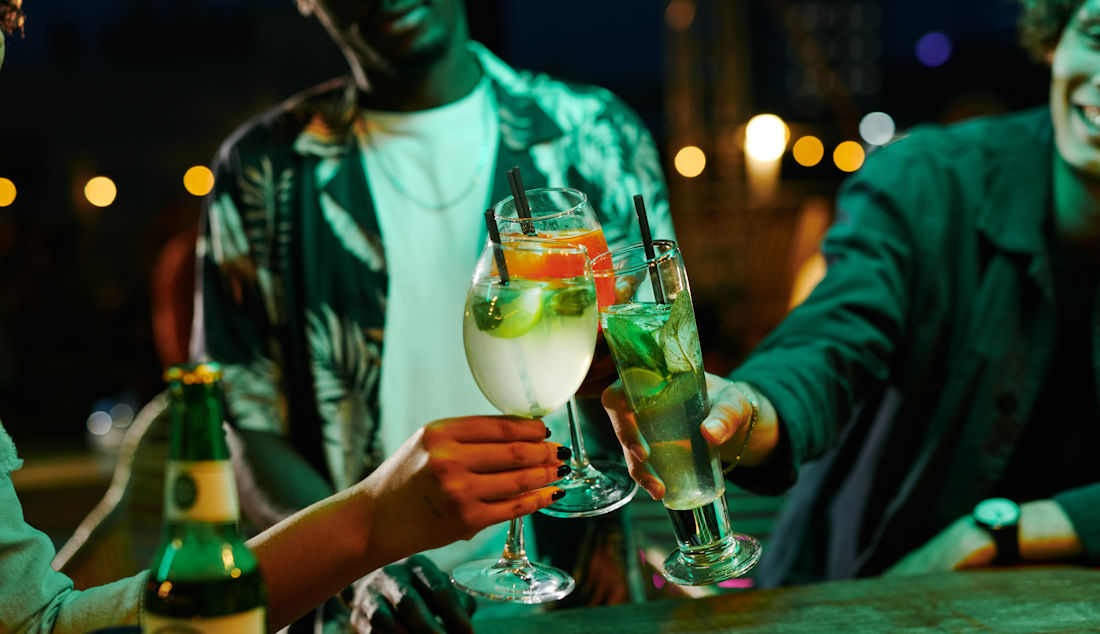 cheer-ing drinks out at a bar