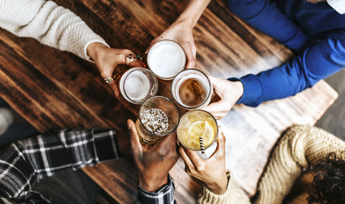 friends cheers-ing with beers